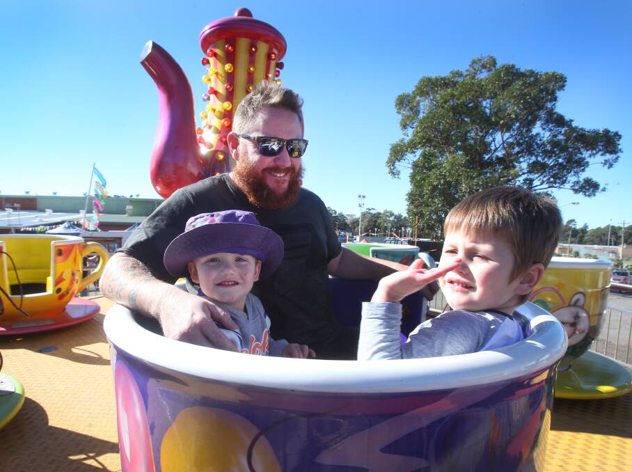 IT'S SHOWTIME: Adam Cole, Gus Cole, two and Hugo Cole, aged four enjoyed the fun of the amusement rides when they took a spin on the tea cups at the Bulli Show. 
