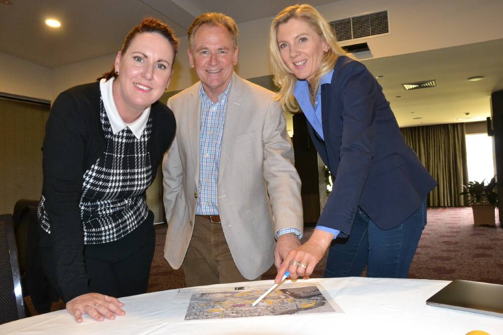 Illawarra Chapter of the Property Council director Kim Rawson, chairperson Mark Jones and deputy chair Jennifer Macquarie look over plans for the Bomaderry affordable housing project.