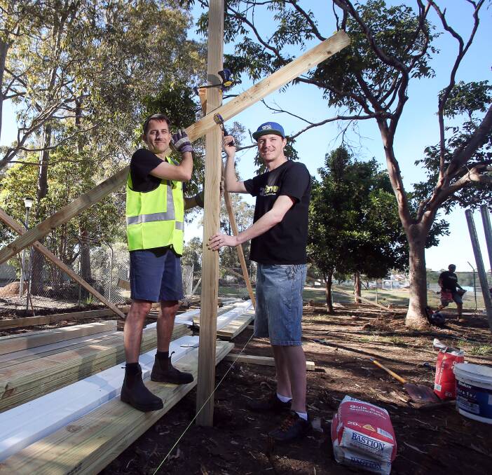 HELPING: CityServe Shellharbour volunteers visited Lake Illawarra High to build a bespoke outdoor learning facility specifically for students with special needs. Pictured are Glenn Fairweather and Pat Steele. Picture: Sylvia Liber