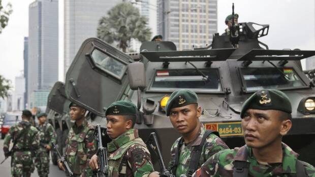 Indonesian soldiers stand guard in Central Jakarta, Indonesia on Thursday. Photo: AP