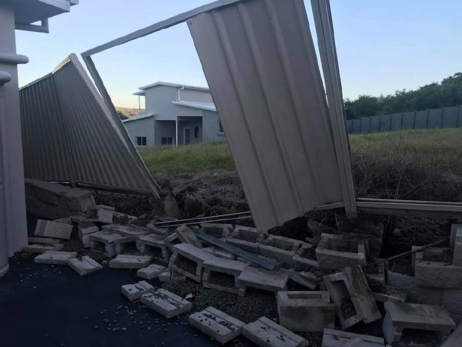 BLOWOUT: A collapsed fence and retaining wall at Shell Cove. Picture: Esse Newman