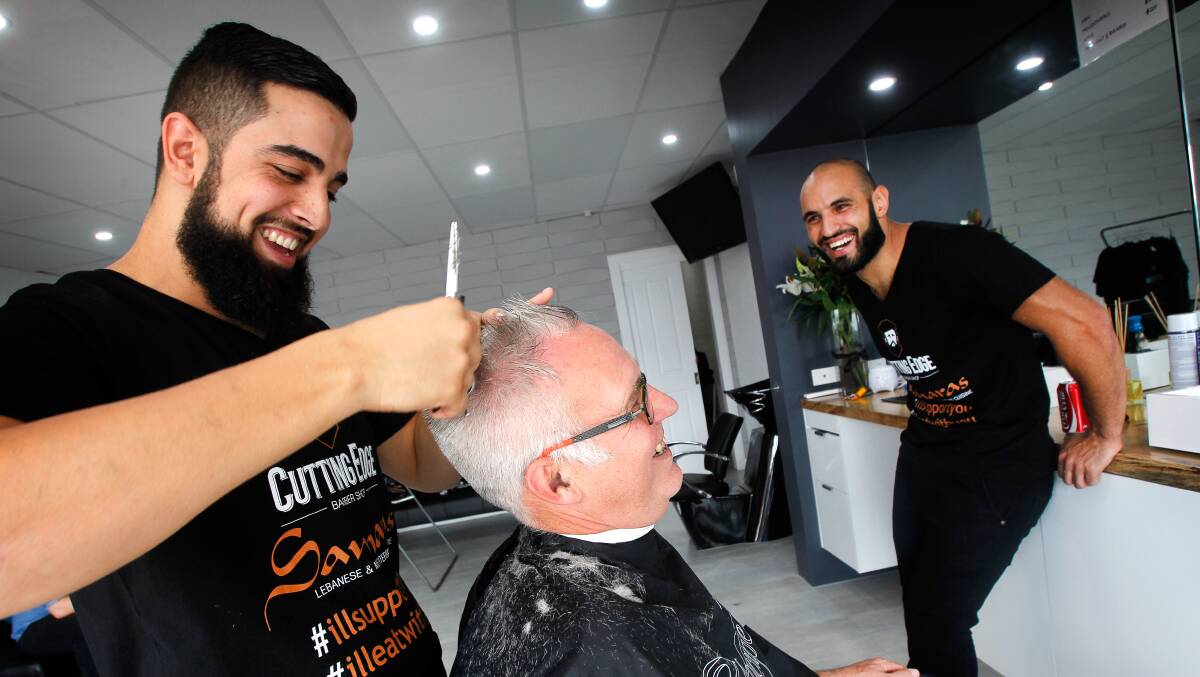 Lifeline director Graham Gould getting hair cut by Bilal El-Mohamad and Omar Nemer.