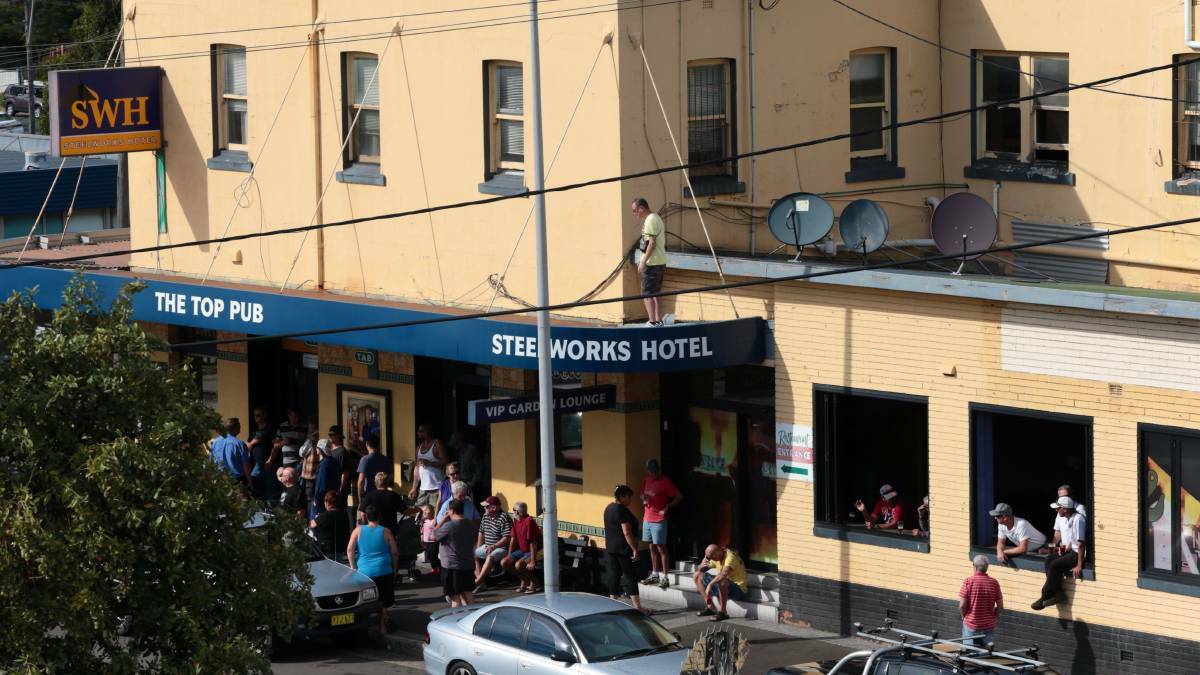 People gathered at the Port Kembla Steelworks Hotel as they waited for the stack’s demolition. Picture: ADAM McLEAN
