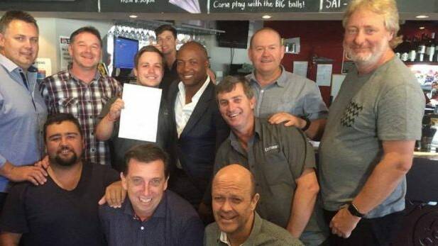 West Indian cricket great Brian Lara and members of the Bennett Hotel Centurions after he signed on with the club in Wickham on Friday. Photo: Supplied
