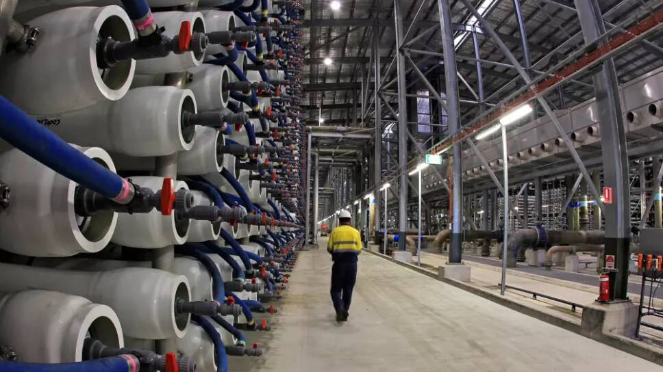 An employee of the Sydney Desalination plant walks past some of its 36,000 polymer membranes used to filter salt and other impurities from seawater so that it can suitable for drinking. Photo: Supplied