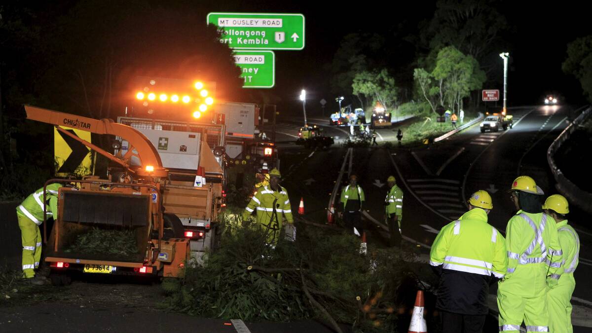 Roads and Maritime Services crews during a previous night closure of Picton Road. That road and a large section of the M1 Princes Motorway will be closed on Sunday night.