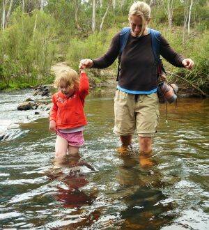 Mrs Yowie helps Emily across the river on the walk to the Big Hole. Photo: Tim the Yowie Man
