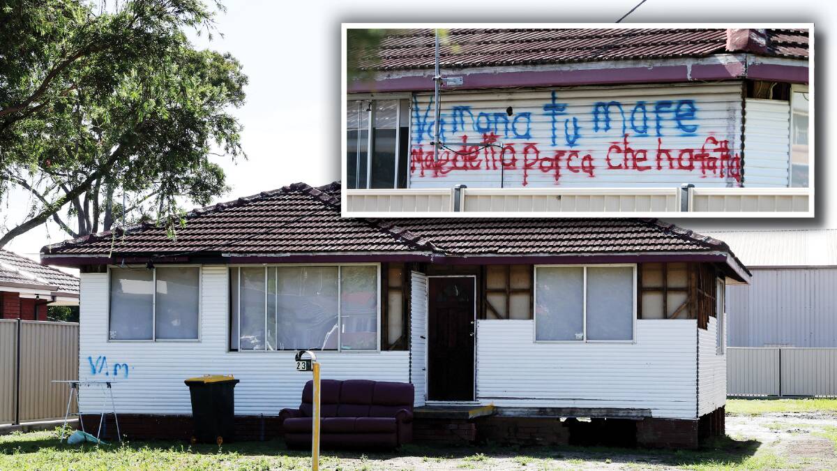 Some of the cladding has been ripped off Soster's house, exposing the structural beams and, inset, vile language painted on the side of property in Italian. Pictures by Sylvia Liber