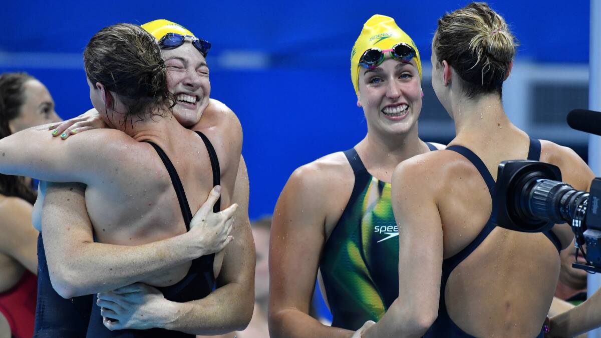 The Aussies celebrate after their record-breaking swim. Photo: Joe Armao