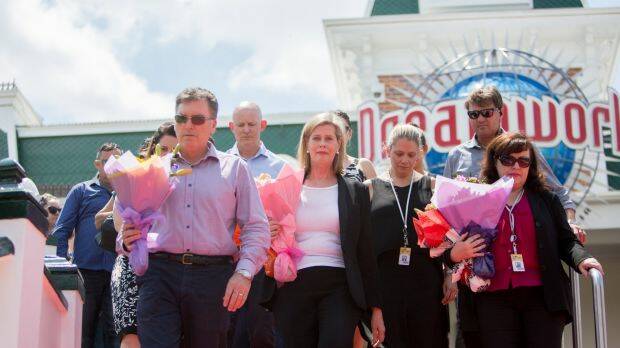 Dreamworld chief executive Craig Davidson and Ardent Leisure boss Deborah Thomas leave flowers at the site on Friday. Photo: Tammy Law
