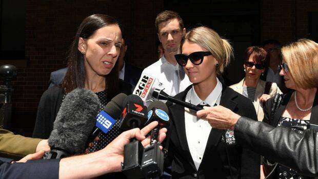 Leanne Adam, (left), the daughter of Keith Cini, along with Kirby Delamont, a victim of one of the home invasions are seen outside the NSW Supreme Court on Friday Photo: AAP
