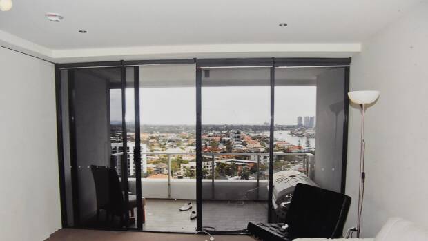 The scene of the tragedy: looking out from Tostee’s unit to the balcony where he isolated her, and the railing over which she climbed before falling to the ground. Photo: Supplied


