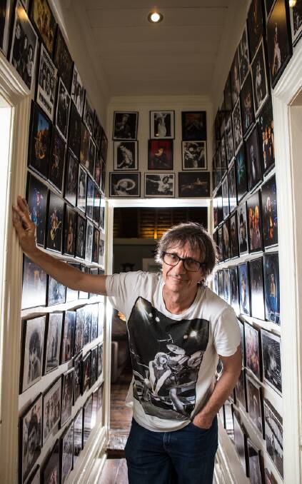 Tony Mott at home with some of the photos taken during his 30 years as a rock photographer. Picture: Graham Jepson