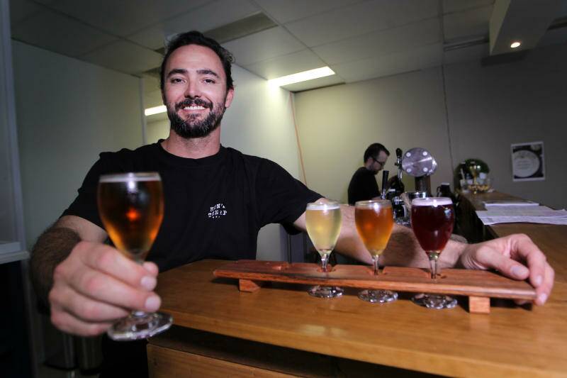 Illawarra meadmaker Joel Robinson with some samples of his meads - which are far from the honey-sweet versions you may have tried in the past. Picture: Sylvia Liber