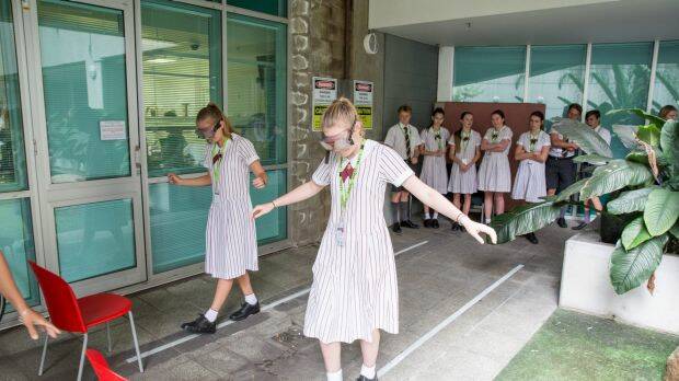 Students attempt activities such as walking a straight line with impaired vision. Photo: Paul Harris
