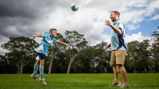 Adam Hollingworth – football coach and dad – has been told to sign a contract that allows the FFA free use of his name and image, or walk away from his son Tully's team. Photo: Anna Kucera
