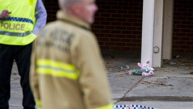 Police and ACT Fire & Rescue crews outside the Queanbeyan unit where a fire claimed the life of a one-year-old girl. Photos: Jay Cronan