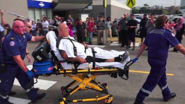A victim is taken away after the shooting at Bankstown Central Shopping Centre. Photo: Top Notch Video