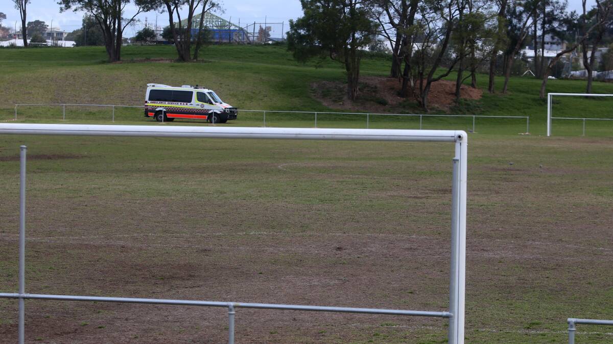 One of three ambulances remained near the soccer field after the emergency at Gibson Park on Saturday afternoon. Picture: Robert Peet