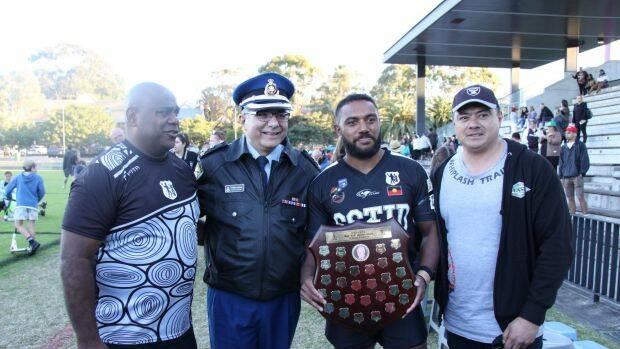 Acura Niuqila (with trophy) celebrates with Tribal Warriors CEO Shane Phillips, Pat Aboud and correctional officer Peter Shiraz after helping Redfern All Blacks win a grand final against Coogee Randwick. Photo: Corrective Services

