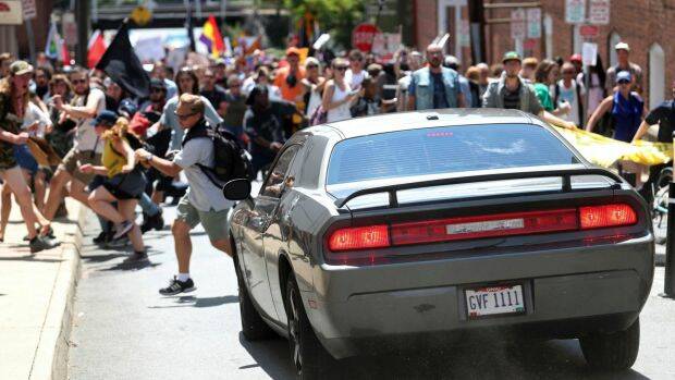 A vehicle drives into a group of protesters demonstrating against a white nationalist rally in Charlottesville. Photo: Ryan M. Kelly
