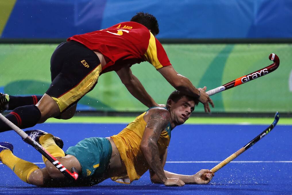Spain's Miguel Delas fights for the ball with Australia's Blake Govers. Photo: AP 
