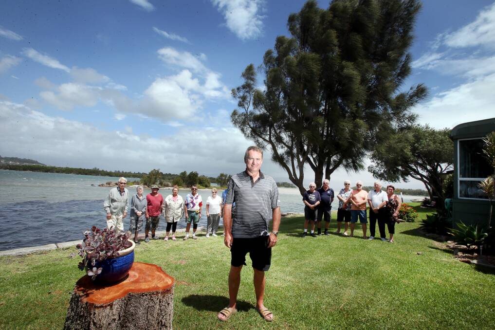 Lake locals: Steve Thompson (front) and Oaklands residents are sick of trespassers abusing their property on the edge of Lake Illawarra. Picture: Sylvia Liber