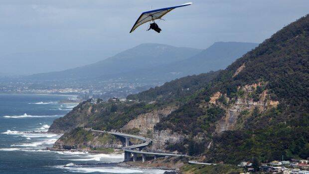A hang glider takes off from Bald Hill on Stanwell Tops. Photo: Kirk Gilmour
