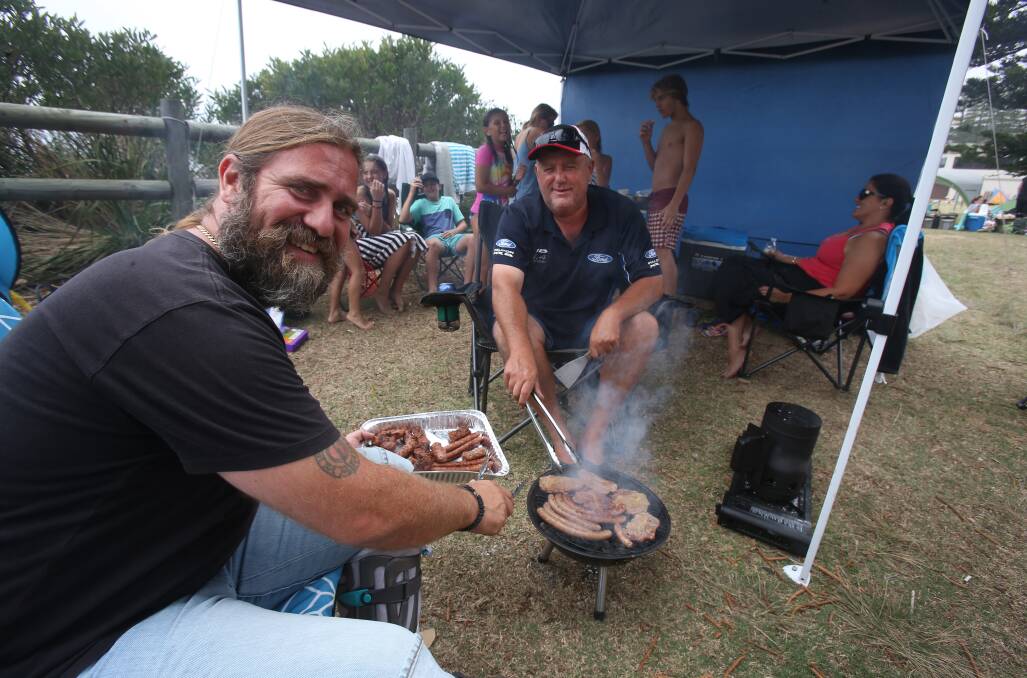 Boro Selak and Alex Luzaic man the barbecue at Stuart Park on Saturday afternoon. Photo: Robert Peet