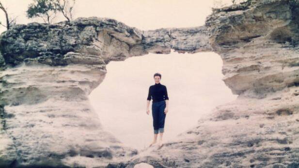 A lady poses for a photo at the Hole in the Wall, circa 1960. Photo: Jervis Bay Maritime Museum

