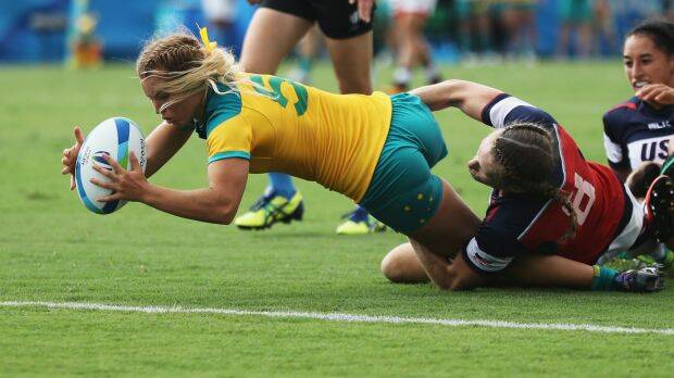 Emma Tonegato of Australia dives to score the try against Carmen Farmer of the United States during the Women's Pool A rugby match. Photo: David Rogers
