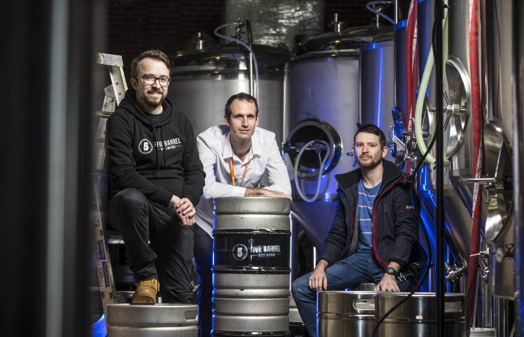 Michael Burton (centre) is working on a way to detect when beer kegs are almost empty.