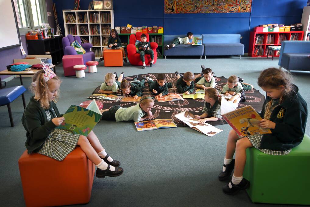Mount Ousley Public students reading on comfy, mobile furniture in the library.