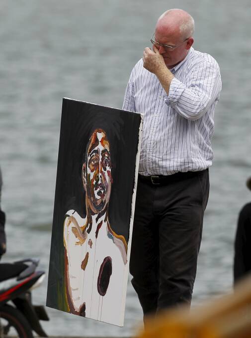 Last days: Lawyer Julian McMahon carries a self-portrait painted by Australian death row prisoner Myuran Sukumaran. Picture: REUTERS