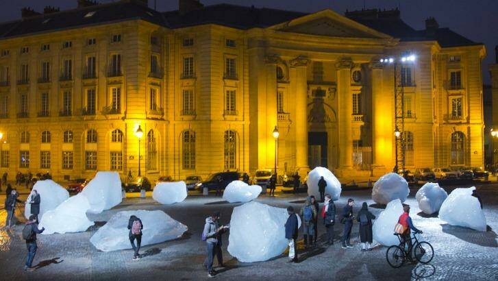 Visitors walk through ice blocks as part of the sculpture Ice Watch, by Danish artist Olafur Eliasson, as part of the Paris climate talks.  Photo: Jacques Brinon