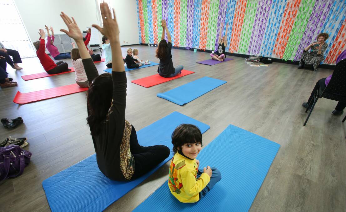 Farbod Ghafarnezhad with his mother do yoga at an open day for Community Gateway’s new  hub. Picture: KIRK GILMOUR