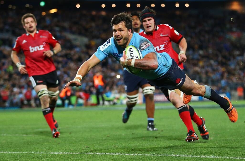 Adam Ashley-Cooper dives to score a try for the Waratahs during the Super Rugby Grand Final against the Crusaders at ANZ Stadium on Saturday night. Picture: MARK NOLAN/GETTY IMAGES