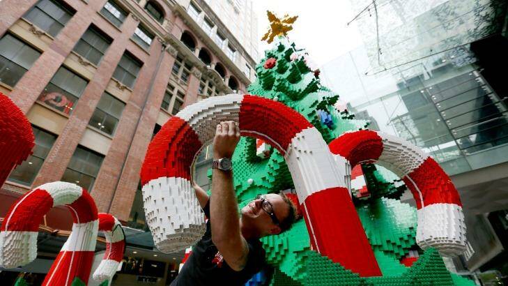 Finishing touches: Johnno Austin puts the final bricks in the Pitt Street Mall Lego Christmas tree. Photo: Michele Mossop