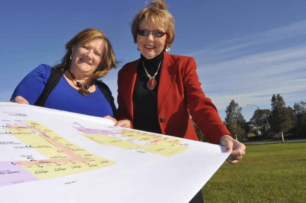 Shellharbour Mayor Marianne Saliba and KidzWish founder Chris Beaven look over the plans for the new centre. Picture: ELIZA WINKLER