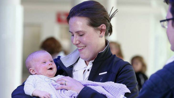 Liberal MP Kelly O'Dwyer, with her 12-week-old daughter Olivia, arrives at Canberra Airport. Photo: Alex Ellinghausen