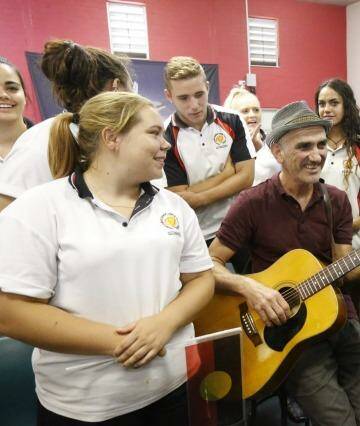 Freedom Ride 2015: Singer Paul Kelly sings a song with Dubbo school students at Dubbo Senior Campus. Photo: Peter Rae