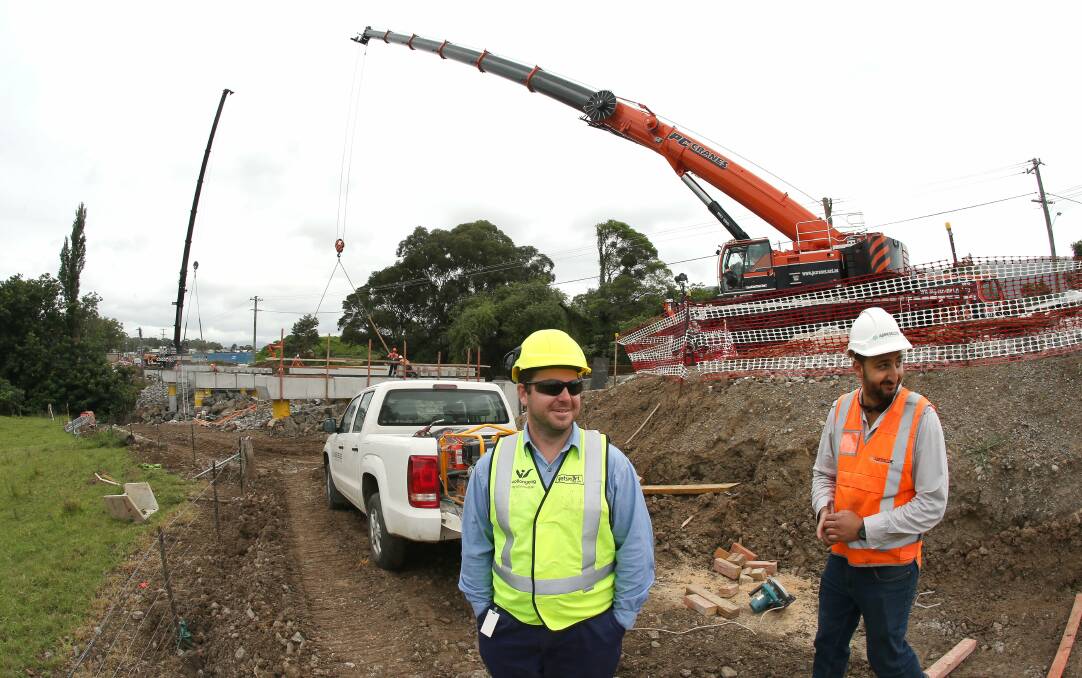Wollongong City Council senior project manager Christopher Brown with Abergeldie project engineer Joseph Maklouf at the Shone Ave, West Dapto road project. Two 200-tonne cranes are being used to build the bridge. Picture: KIRK GILMOUR