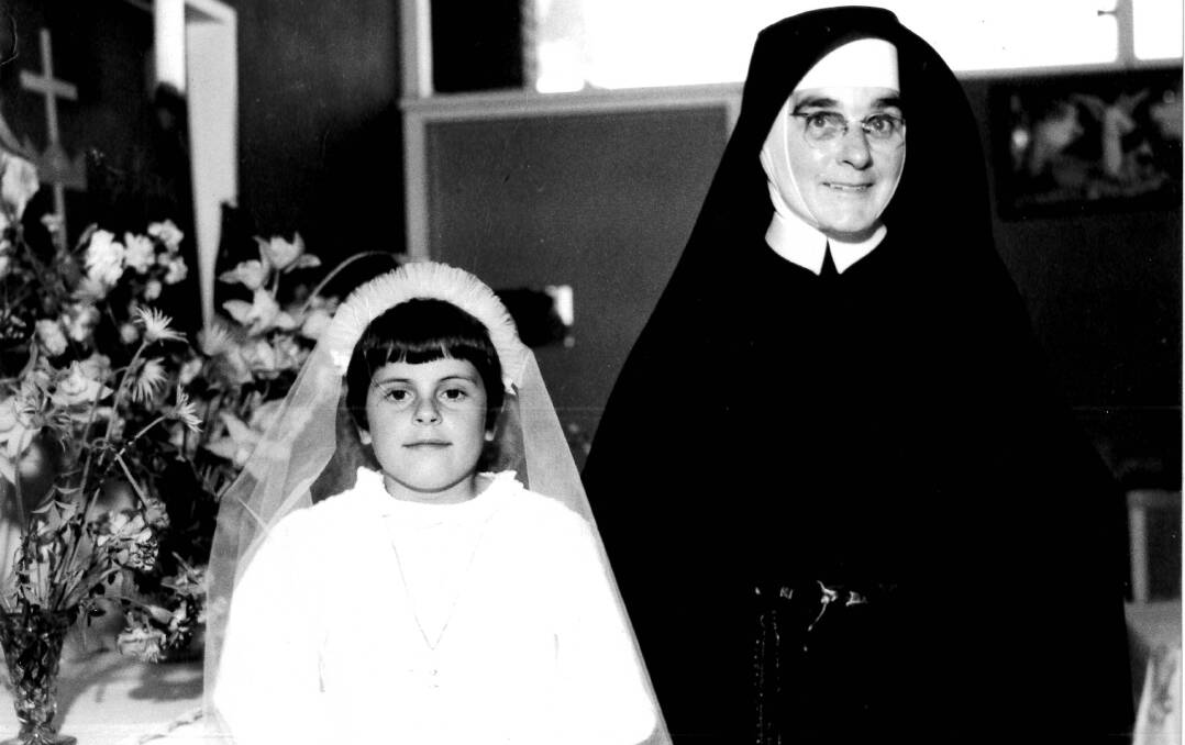 St Michael’s founder Sister Thecla Sullivan with a student on Holy Communion Day.