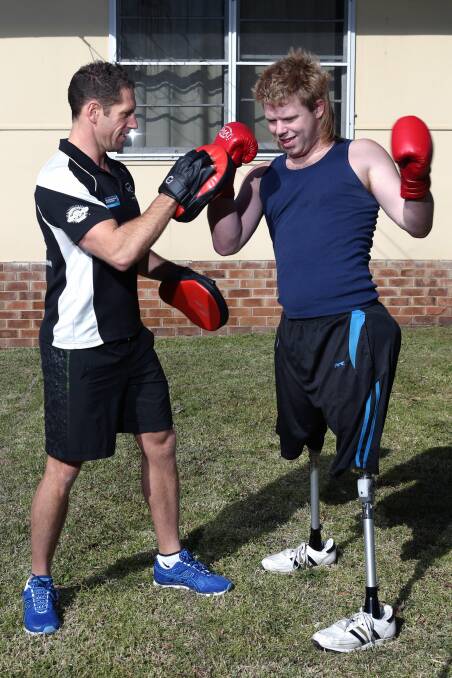 Double amputee Toby Lyndon, training with Brendan, in 2012. Picture: ADAM McLEAN