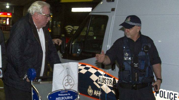 Andrew McManus being detained by police in Melbourne on Thursday night. Photo: Luis Enrique Ascui