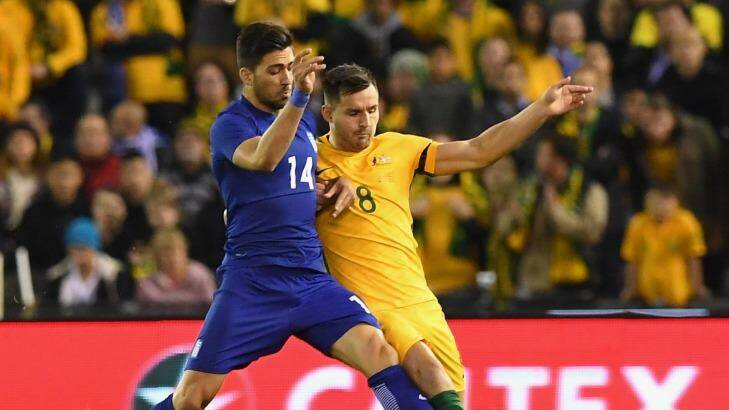 Anastasios Bakasetas of Greece and Australia's Bailey Wright vie for the ball in a friendly at Etihad Stadium in Melbourne on June 7. Photo: Quinn Rooney