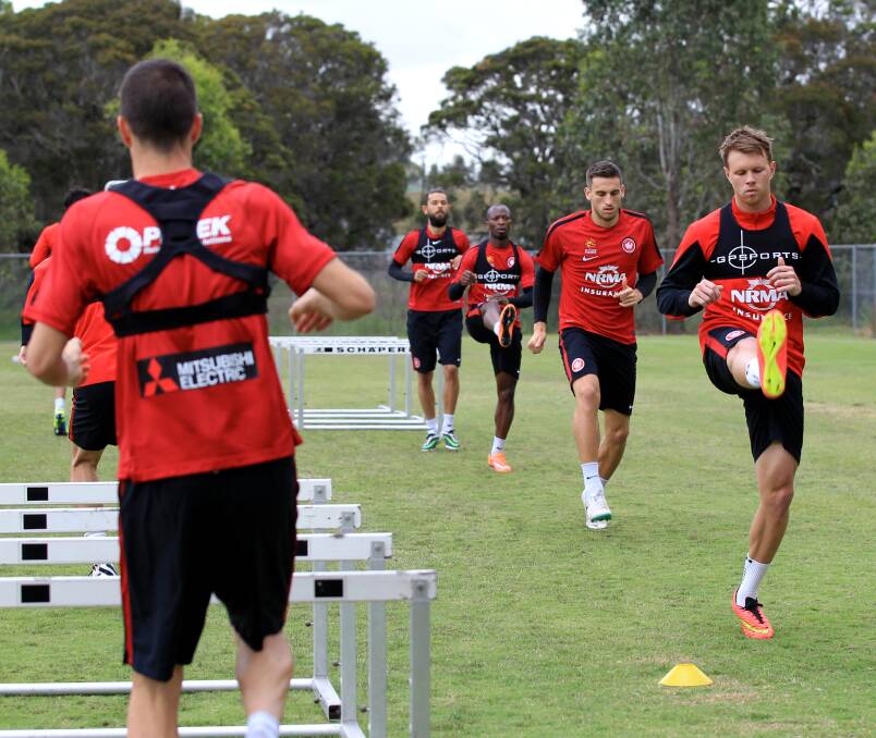 Teamwork: Western Sydney Wanderers players go through their training drills in Blacktown ahead of the two-leg ACL finals series. Picture: JANIE BARRETT