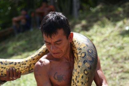 Villagers treat the Anaconda with respect, moving them away from their homes. Photo: Kerry van der Jagt