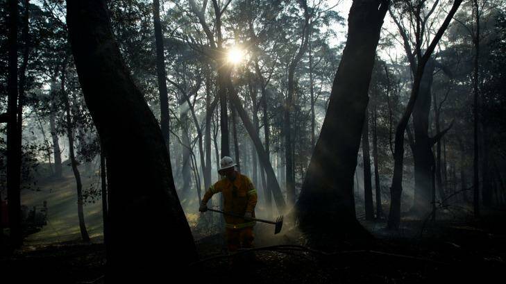 A NSW RFS crew from Kurrajong Brigade works to extinguish a fire that flared around the State Mine fire near Berambing. Photo: Wolter Peeters