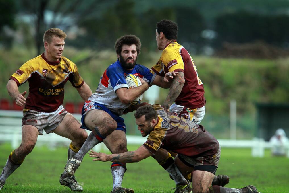 Gerringong's Adam Thomson finds himself outnumbered. Picture: SYLVIA LIBER